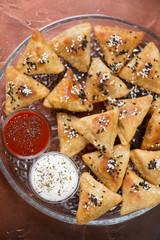 Top view of samosas or pastries with meat stuffing on a tray, close-up, vertical shot