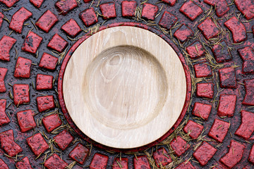 Wooden oak plate on red brick textured background