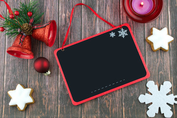 Blank blackboard and Christmas decorations on the dark wooden background