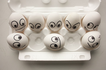 smiling funny eggs with a face on a white