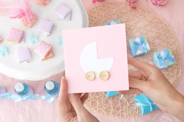 Woman holding Thank you card for baby shower party