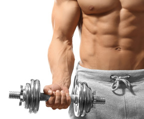 Muscular young man with dumbbell on white background