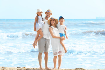 Happy family on sea beach at resort