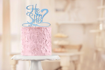 Stand with delicious cake for baby shower party indoors