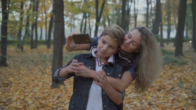 Happy family takes selfie in autumn park