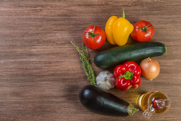 The ingredients for Provencal cooking the Ratatouille on the table made of oak planks. Brown. Proper nutrition and diet concept. Brown. The view from the top. Copy space