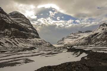 Saskatchewan Glacier Valley and Dramatic Cloudy Sky over Big Bend Peak in Columbia Icefields...