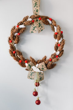 Handmade christmas wreath hanging on the white wall