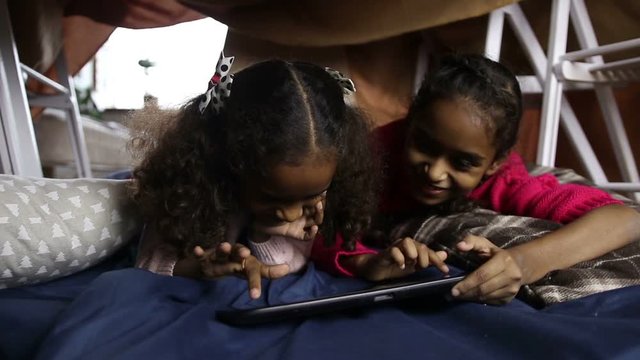 Smiling african american girls using tablet pc