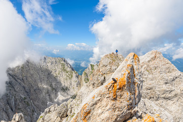 Fototapeta premium Hiker at Ellmauer Halt, Wilder Kaiser mountains of Austria - close to Gruttenhuette, Going, Tyrol, Austria - Hiking in the Alps of Europe