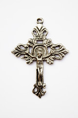 silver cross with a jesus on white background