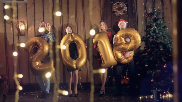 Cheerfull group of friends show real inflated figures 2018. Happy New year 2018 concept.
