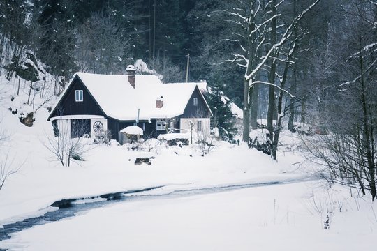 Challet in snowy mountains country, foggy winter day, Czech republic