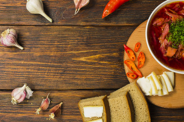 Ukrainian beetroot soup - borscht, on napkin, on wooden background