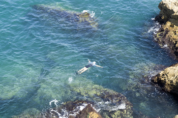 A young swimmer in the turquoise sea