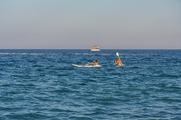 Tourists in kayaks swim the Mediterranean Sea