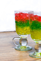 two glasses with chopped colorful jelly from berries