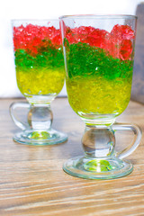 two glasses with chopped colorful jelly from berries