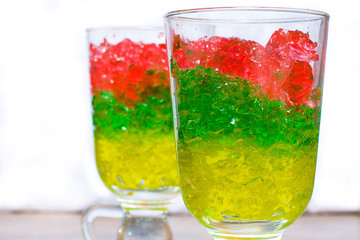 two glasses with chopped colorful jelly from berries