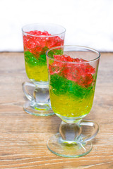 two glasses with chopped colorful jelly from berries