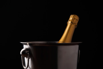 Image of bottle of champagne in iron bucket