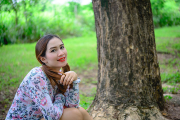 Fototapeta premium Portrait of thai woman under tunnel tree,asian woman in the forest