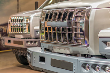 shiny chrome grille trucks standing one behind the other