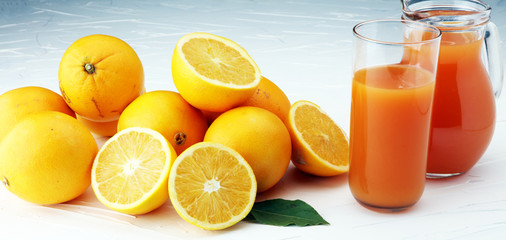Obraz na płótnie Canvas glass jar of fresh orange juice with fresh fruits on white table