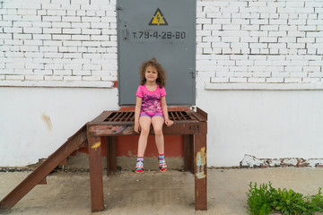 Little girl near the transformer substation