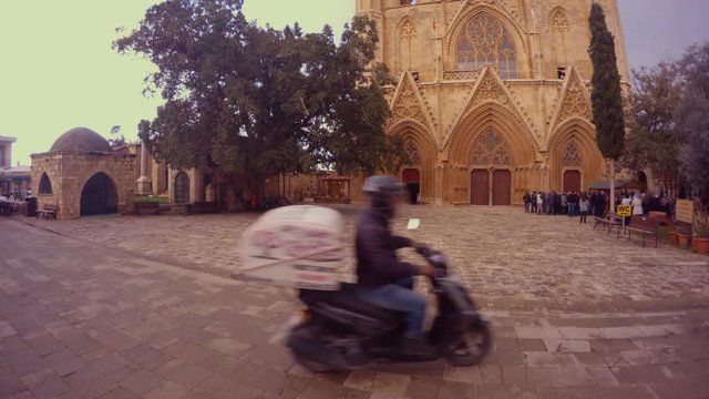 motorcyclist on the square in front of Lala Mustafa Pasha Mosque St Nicholas Cathedral