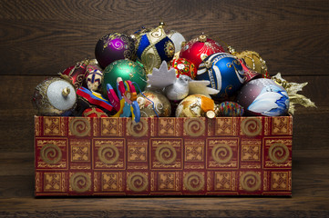Christmas toys in box on wooden background, heap of new year decorations, xmas winter holidays and...