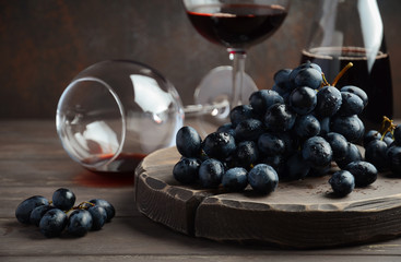 Fresh Black Grapes and Red Wine on Wooden Table Selective Focus