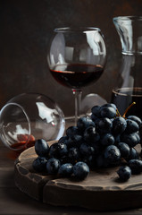 Fresh Black Grapes and Red Wine on Wooden Table Selective Focus