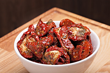 Sun dried tomatoes in white bowl.