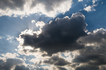 Dramatic sky, sun behind dark clouds