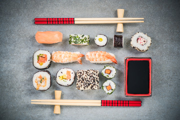 Sushi on stone or concrete slate with chopsticks