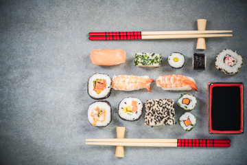 Sushi on stone or concrete slate with chopsticks