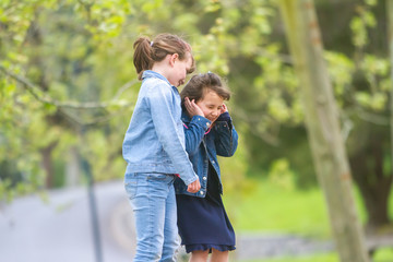Fototapeta premium outdoor portrait of young happy girls having fun on playground