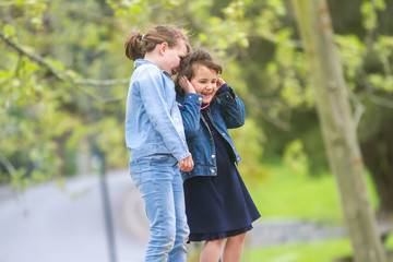 Fototapeta premium outdoor portrait of young happy girls having fun on playground