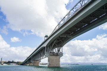 view of Auckland CBD, city center, with sky tower from under the bridge, new zealand