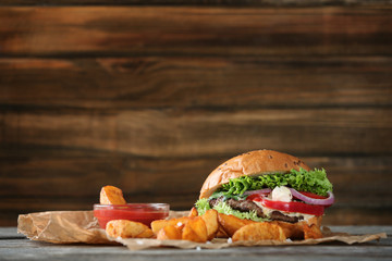 Tasty beef burger on table