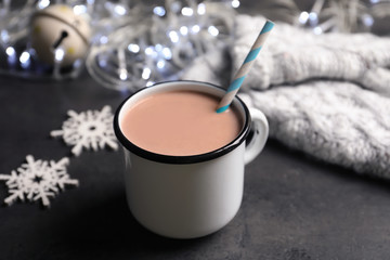Mug with delicious cocoa drink on grey background