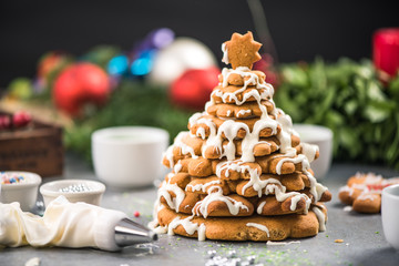 Decorating gingerbread Christmas sweet tree with frosting