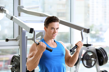 Fototapeta na wymiar Muscular young man training in gym
