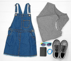 Set of child's clothes on wooden background