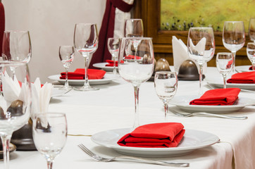 Served table with glasses, cutlery and napkins