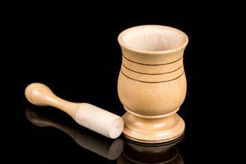 Wooden mortar isolated on black background with reflections