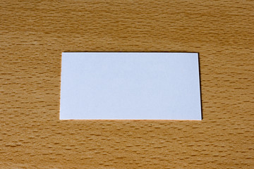 A white card on a wooden table