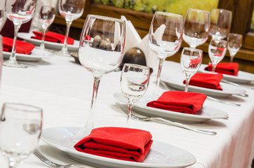 Served table with glasses, cutlery and napkins