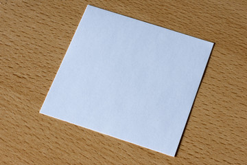 A white card on a wooden table